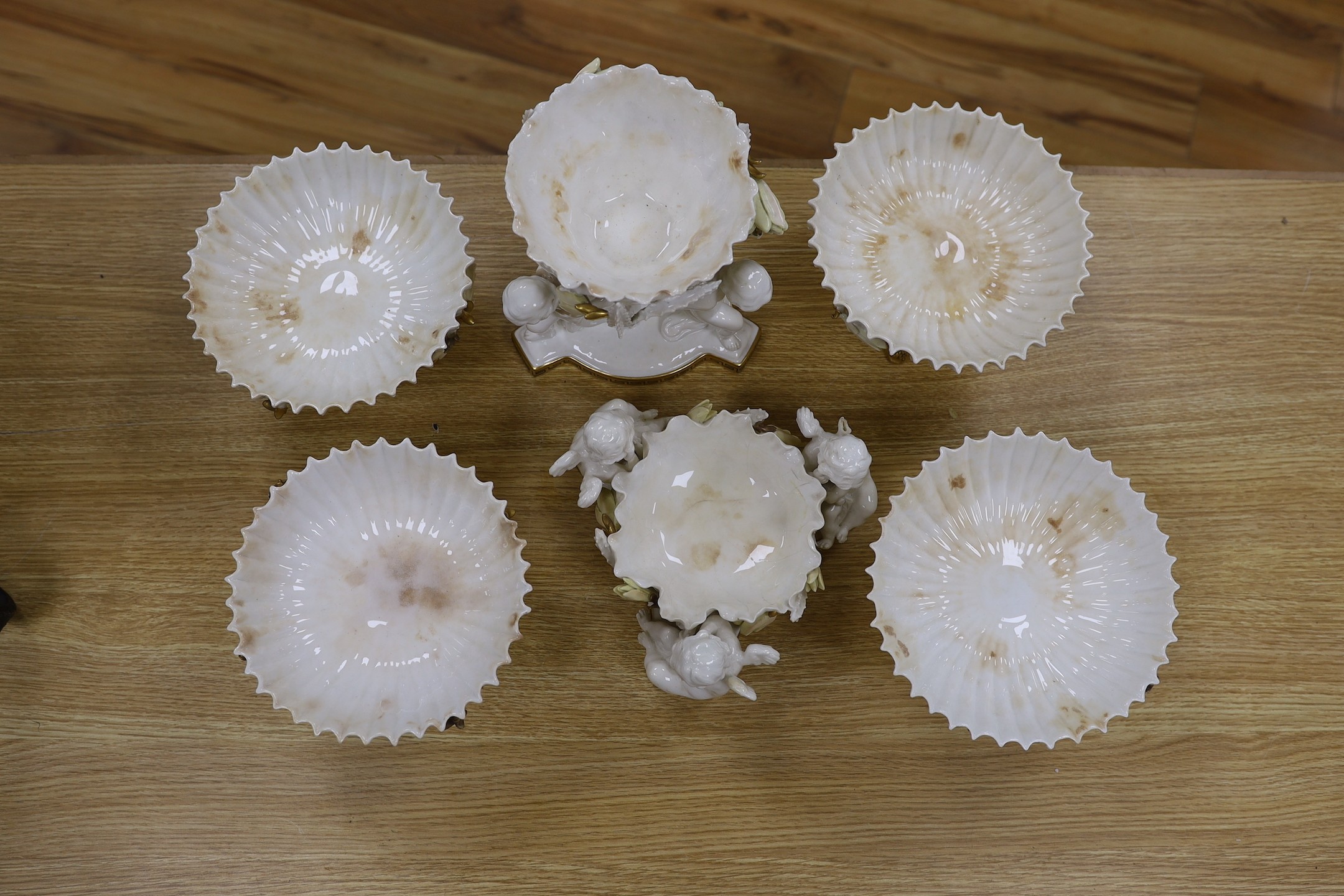 Six pieces of Moore Bros. white glazed gilt edged porcelain, including a set of four comport, 20cm tall